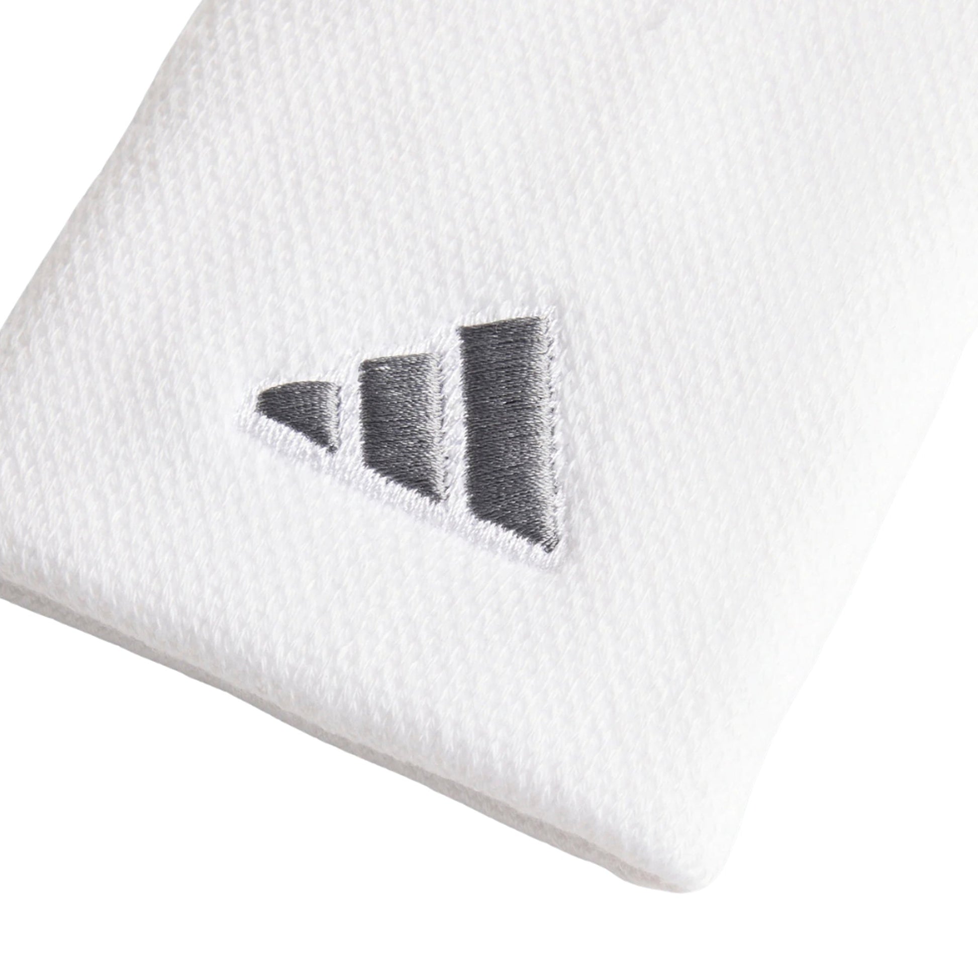 Adidas Large Tennis Wristband in white, close-up of the fabric texture and iron-metallic embroidered logo