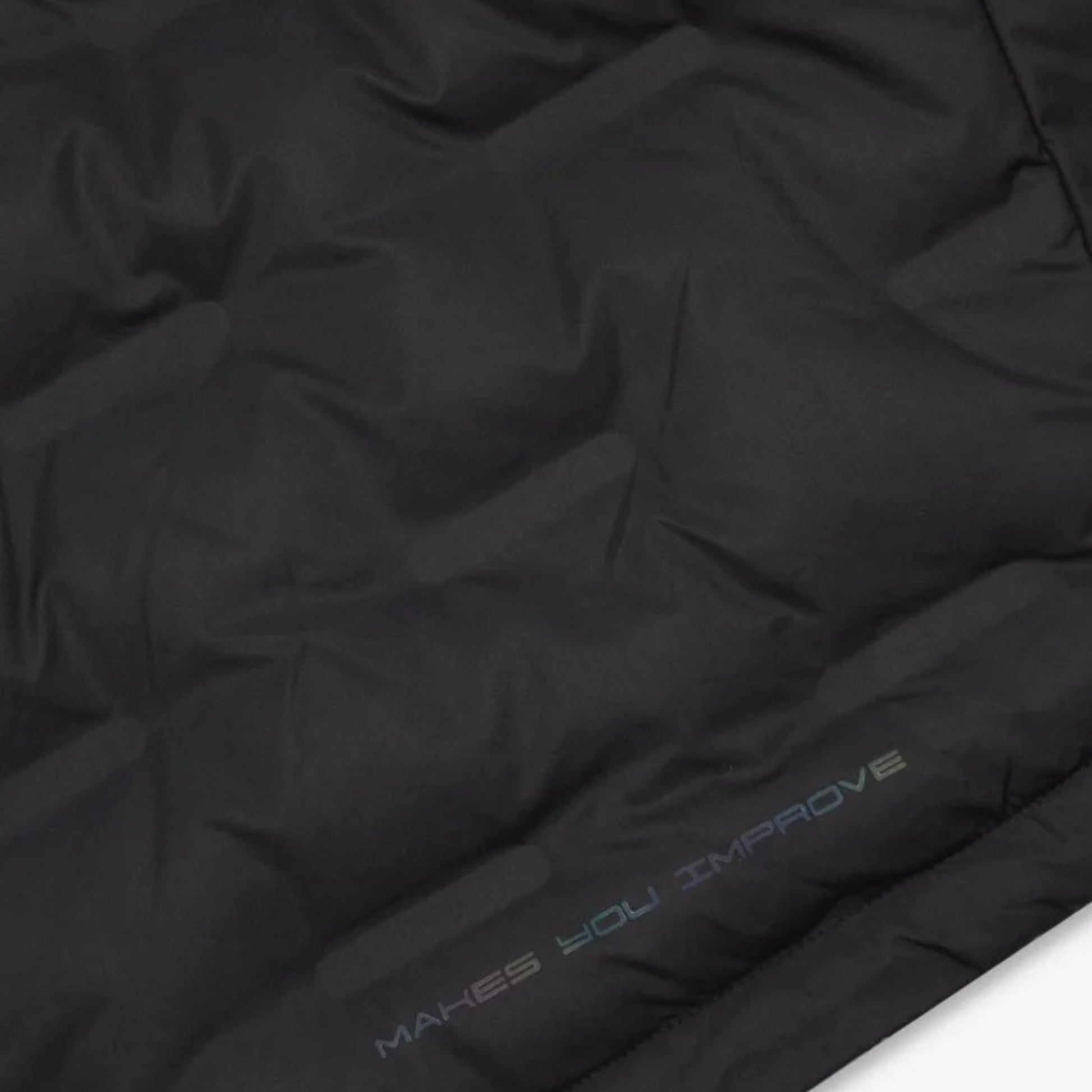 NOX Team Quilted Padel Jacket close-up, black quilted panels and hem branding